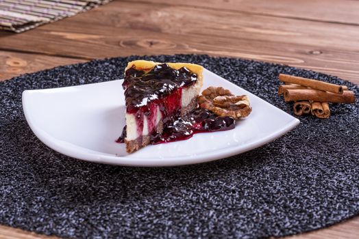 Piece of blueberry cheesecake on a plate with a silver fork.
