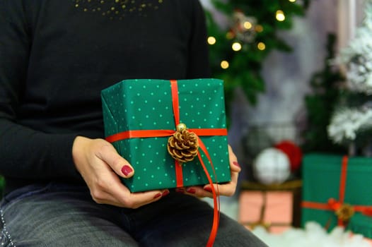 Female's hands in pullover holding Christmas gift box.Christmas and New Year banner.