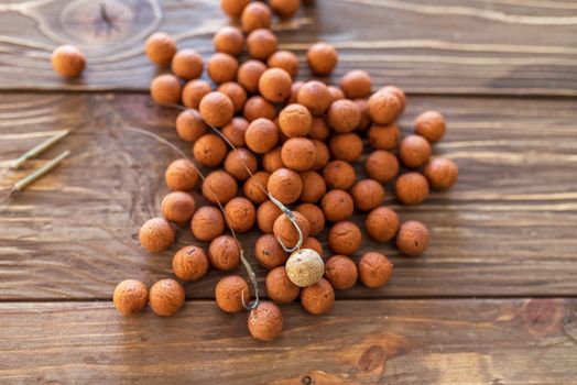 Carp fishing. Different of carp boilies and accessories for carp fishing isolated on wooden background.
