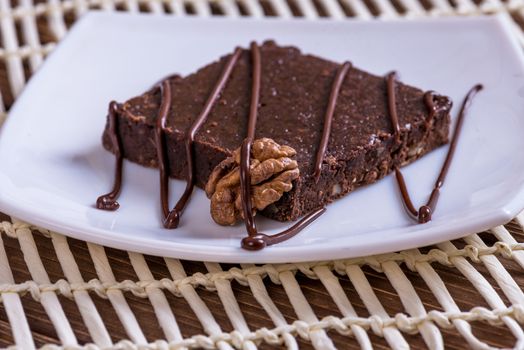 A slice of chocolate cake on table.