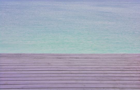 wooden platform beside blue sky beach