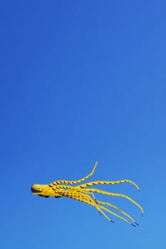 Yellow kite on a blue sky