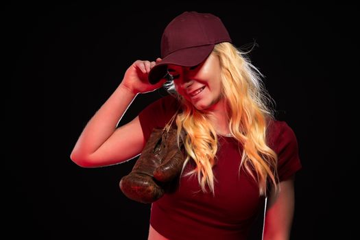 portrait of woman with old boxing gloves on black background, copy space.