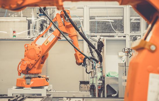 robotic automatic arms in the factory stopped because of slowing the economy and stop production.