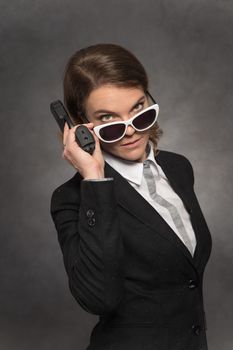 Portrait of woman with gun on black background.