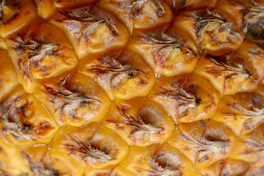 Close-up of skin of ripe pineapple. Fresh pineapple texture. Abstract nature background texture of pineapple skin. The skin is were most of the bromelain, a protein that helps in digestion and healing