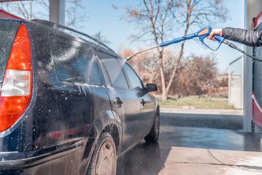 manual car wash by spraying treated water under high pressure.