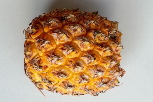 Close-up of skin of ripe pineapple. Fresh pineapple texture. Abstract nature background texture of pineapple skin. The skin is were most of the bromelain, a protein that helps in digestion and healing