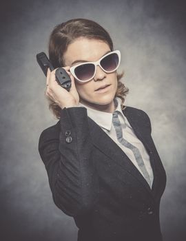 Portrait of woman with gun on black background.