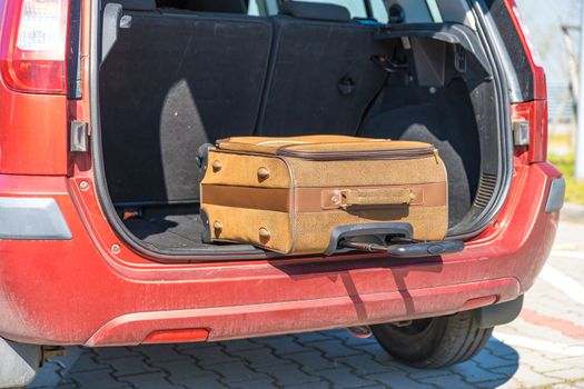 luggage in the trunk of a passenger car.