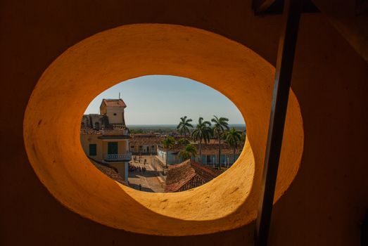 Top view of the Cuban city from a circular window. Trinidad on Cuba. Plaza mayor and Church of the Holy Trinity.