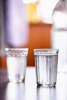 Glasses of fresh water with condensation on a table
