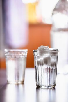 Glasses of fresh water with ice on a table