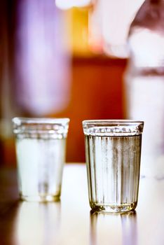 Glasses of fresh water with condensation on a table