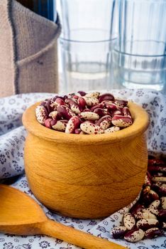 Red Cannellini beans in a wooden bowl on a flourish tablecloth