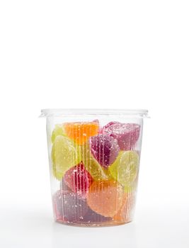 Colorful fruit jelly in foam jar, on white background