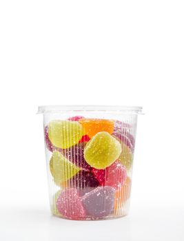 Colorful fruit jelly in foam jar, on white background