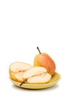 Two yellow and red juicy duchess pears in a yellow plate, isolated on white background