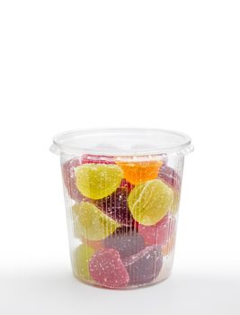 Colorful fruit jelly in foam jar, on white background