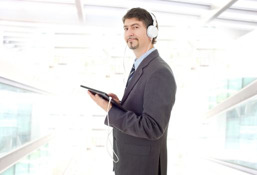 businessman working with tablet pc and headphones, at the office