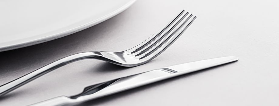 Empty plate and cutlery as mockup set on white background, top tableware for chef table decor and menu branding design