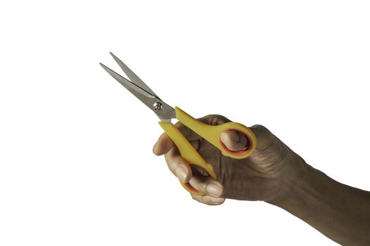 Hand holding a scissors with yellow plastic handle and clipping path isolated on a white background.