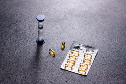 Omega 3 capsules on black dark background. Dietary supplements