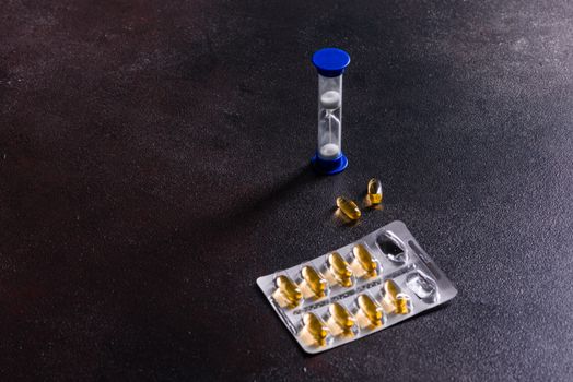 Omega 3 capsules on black dark background. Dietary supplements