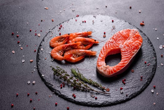 Raw trout red fish steak served with herbs and lemon and olive oil on a dark background. Cooking Salmon, sea food. Healthy eating concept
