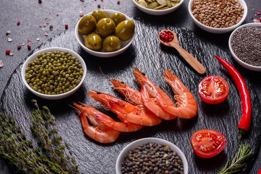 Fine selection of jumbo shrimps for dinner on stone plate. Food background
