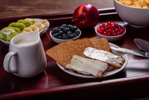 Delicious breakfast with fresh croissants and ripe berries on a beautiful wooden table