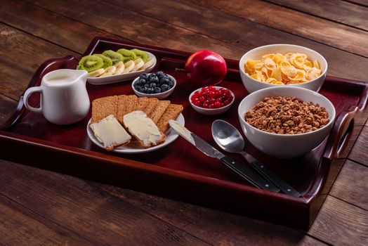 Delicious breakfast with fresh croissants and ripe berries on a beautiful wooden table