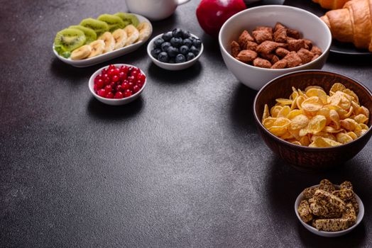 Delicious breakfast with fresh croissants and ripe berries on a beautiful wooden table