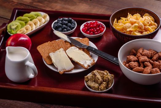 Delicious breakfast with fresh croissants and ripe berries on a beautiful wooden table