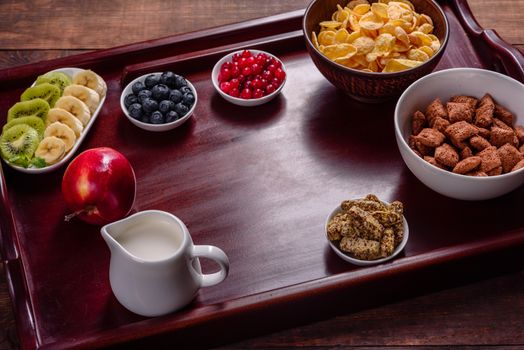 Delicious breakfast with fresh croissants and ripe berries on a beautiful wooden table