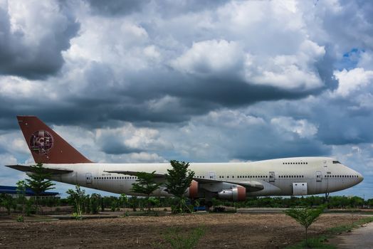 Nakhon Pathom, Thailand - June, 09, 2020 : The old commercial aircraft was discharged with a stormy sky at Nakhon Pathom, Thailand