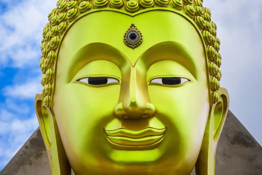 The face of Big Goldden Buddha statue of Chareon Rat Bamrung Temple (Nong Phong Nok Temple) the place of faith in Thailand