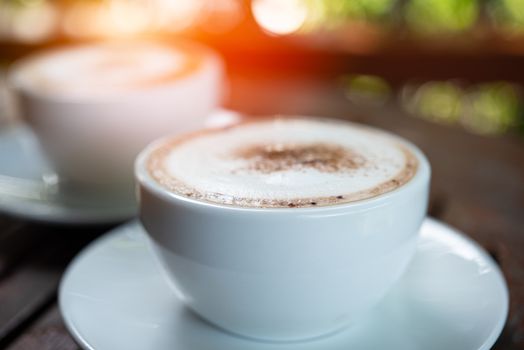 Coffee drink in the white coffee cup on wood table for serve to customers at coffee shop cafe or restaurant