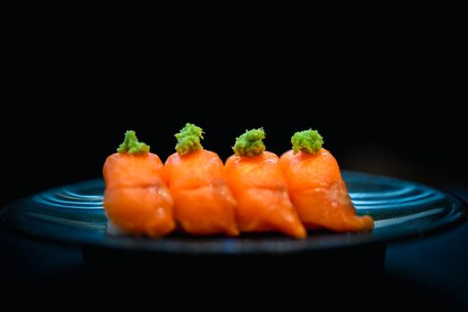 Japanese food in set different types of sushi with seaweed salad and gari (ginger) is a healthy food at the upper right of the serving board in japan restaurant