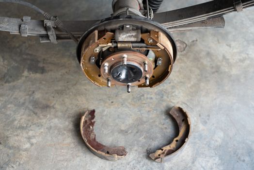 Drum brake and asbestos brake pads it's a part of car use for stop the car for safety at rear wheel this a new spare part for repair at car garage