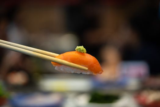 Japanese food in set different types of sushi with seaweed salad and gari (ginger) is a healthy food at the upper right of the serving board in japan restaurant