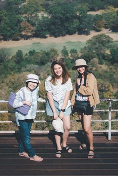 Asian pretty cute women with hat relax at seaside city landscape viewpoint on mountain with happy and freedom emotion in concept travel, vacation, leisure in life