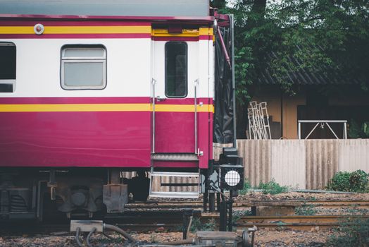 Railway train on the railroad tracks in Bangkok station. Many people in Thailand popular travel by train because it is cheaper.