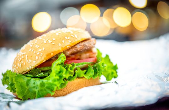 Hamburger is a fast food make from bun, meat, cheese and vegetable  in fastfood restaurant, unhealthy food or fat concept