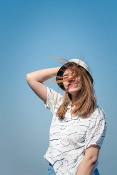 Asian pretty woman with hair blown relax at sea viewpoint with loneliness and lonely emotion in concept travel, vacation, leisure in life