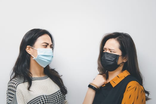 Asian pretty women wearing mask respiratory protection mask against epidemic flu covid19 or corona virus from wuhan in office with fear emotion in concept illness, outbreak, healthcare in life