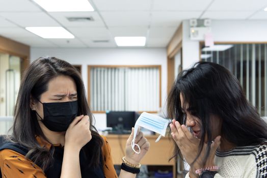 Asian pretty women wearing mask respiratory protection mask against epidemic flu covid19 or corona virus from wuhan in office with fear emotion in concept illness, outbreak, healthcare in life