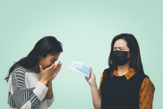 Asian pretty women wearing mask respiratory protection mask against epidemic flu covid19 or corona virus from wuhan in office with fear emotion in concept illness, outbreak, healthcare in life