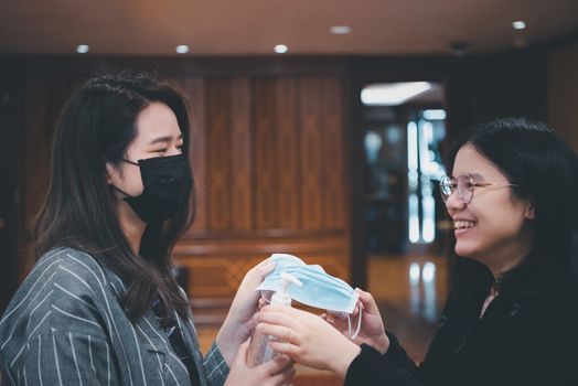 Asian women wearing mask and alcohol antibacterial hand gel respiratory protection mask against epidemic flu covid19 or corona virus with fear emotion in concept illness, outbreak, healthcare in life