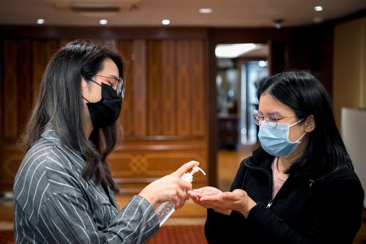 Asian women wearing mask and alcohol antibacterial hand gel respiratory protection mask against epidemic flu covid19 or corona virus with fear emotion in concept illness, outbreak, healthcare in life